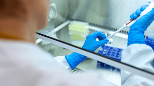 Scientist pipetting sample in contained envronment